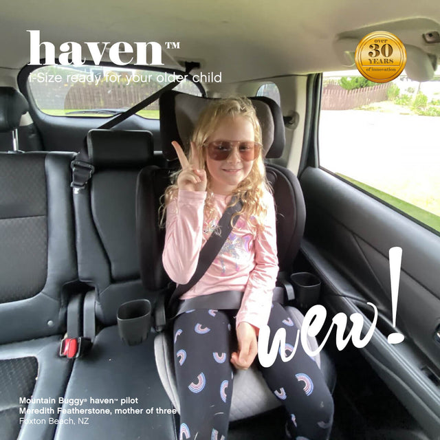 cool kid safely belted into the haven i-Size car seat booster - Mountain Buggy haven™ pilot Meredith Featherstone, mother of three, Foxton Beach, New Zealand