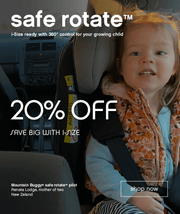 smiling toddler sitting in convertible safe rotate carseat using the suggested rear facing position showing her safety harness - Mountain Buggy