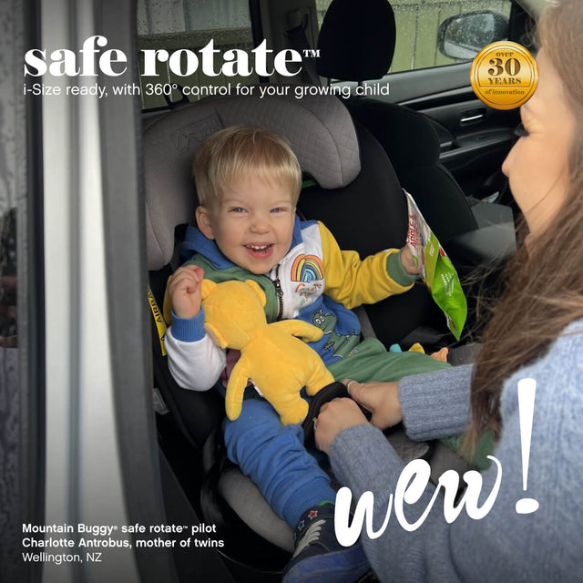 toddler being buckled in to safe rotate™ car seat booster swivelled 90 degrees to face parent outside car door for easy access - Mountain Buggy safe rotate™ pilot Charlotte Antrobus, mother of twins, Wellington, New Zealand