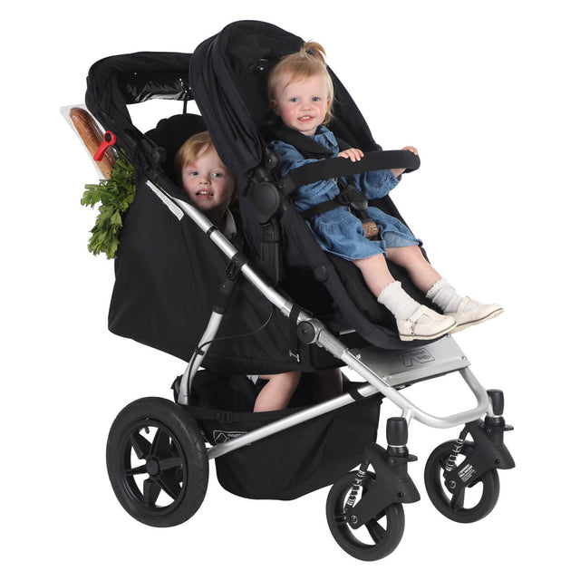 mountain buggy cosmopolitan plus in two toddler mode with shopping in the back - front facing 3qtr view - mountainbuggy.com - fabric colour_black