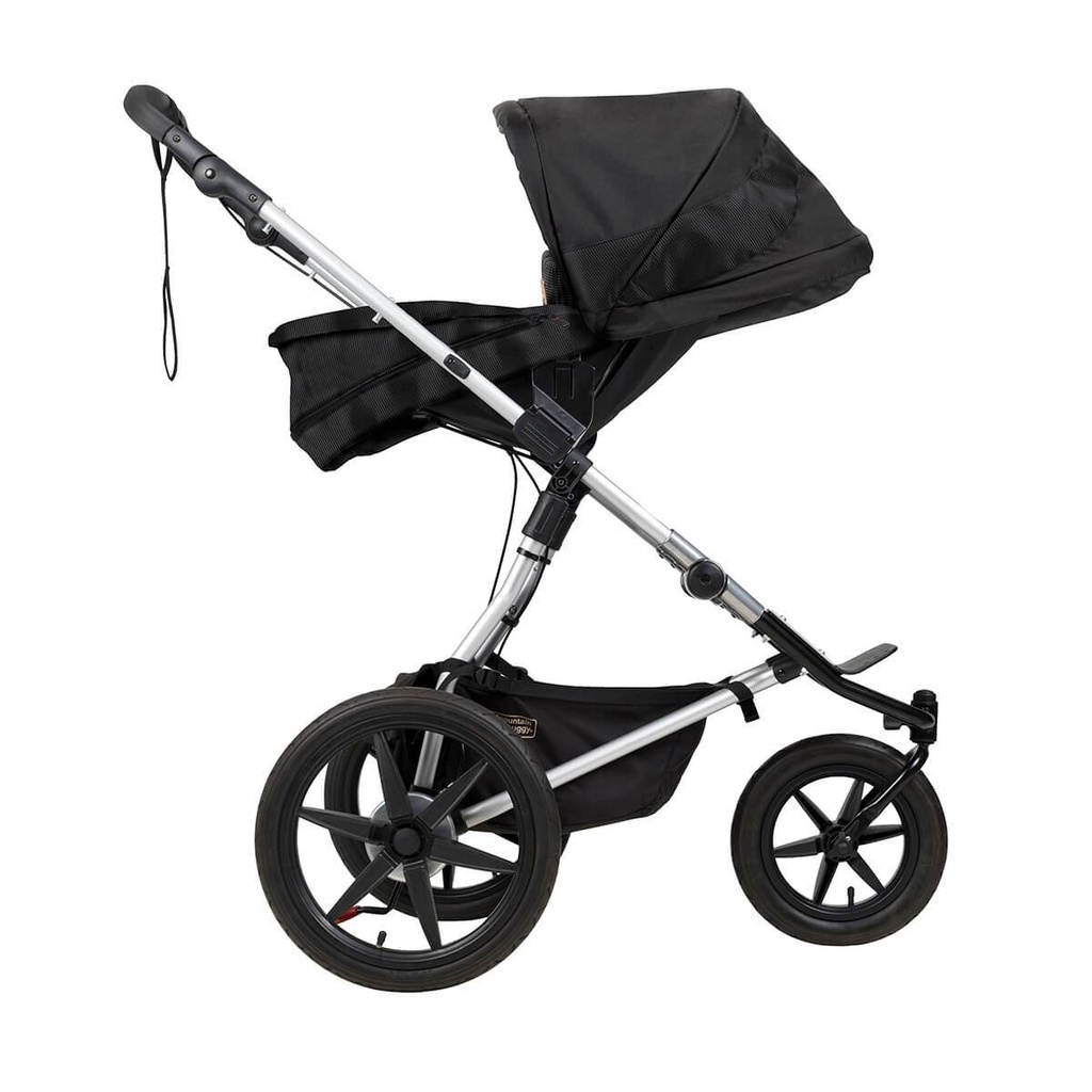 Mountain Buggy carrycot plus on terrain in parent facing mode in colour onyx_onyx