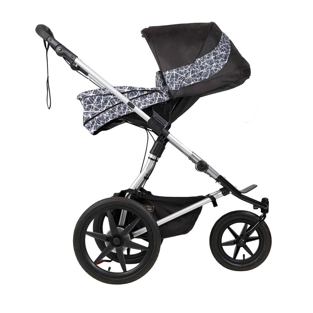 Mountain Buggy carrycot plus on terrain in parent facing seat mode in colour graphite_graphite