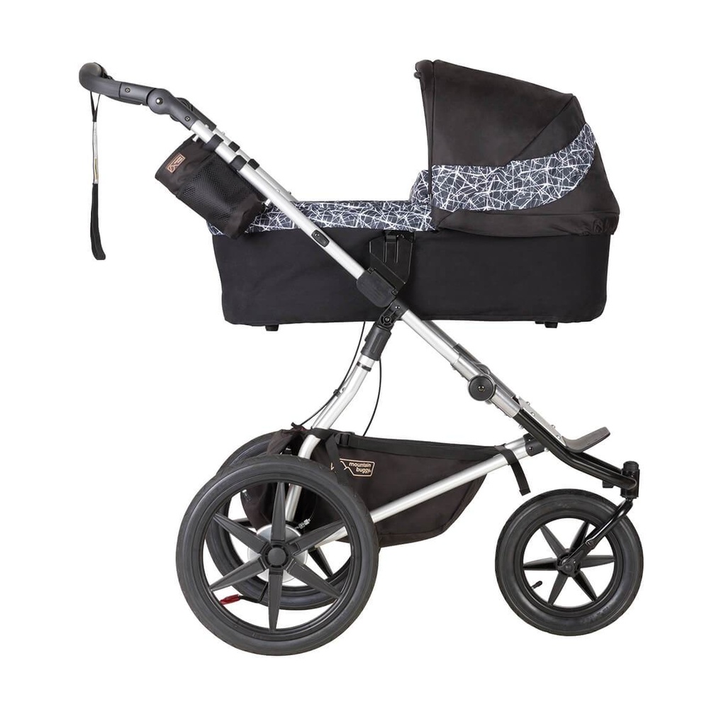 Mountain Buggy carrycot plus on terrain in lie flat mode in colour graphite_graphite