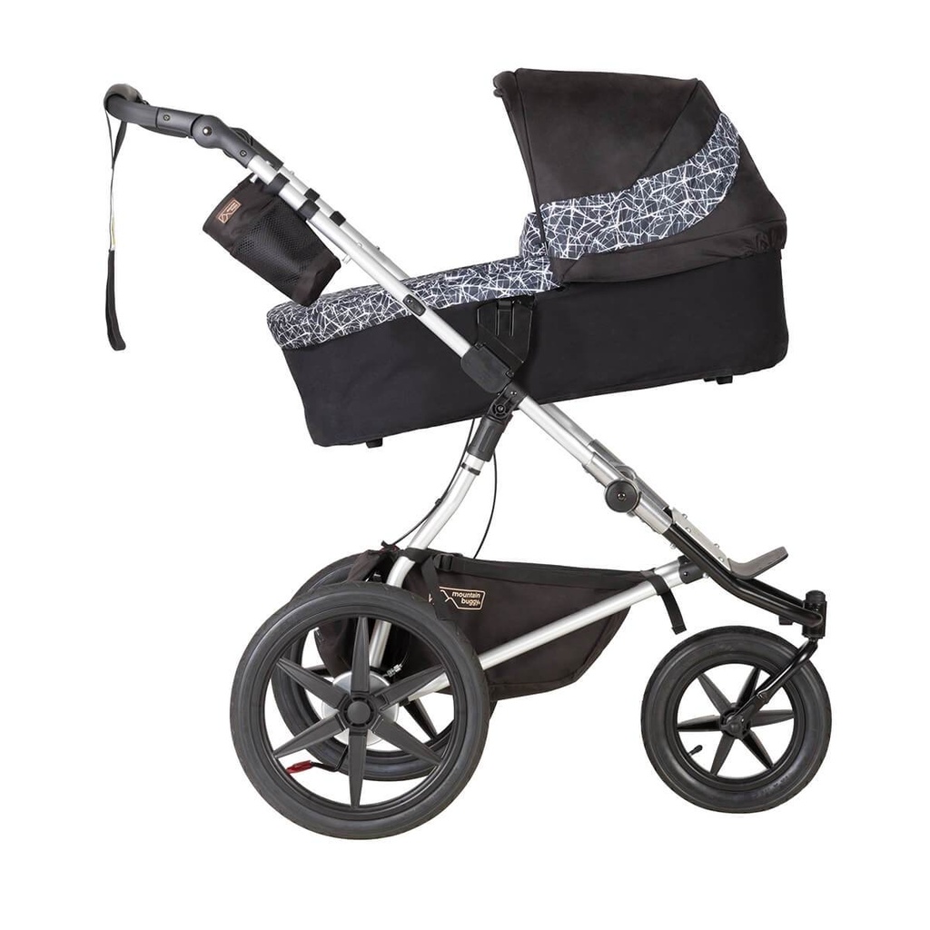 Mountain Buggy carrycot plus on terrain in incline mode in colour graphite_graphite